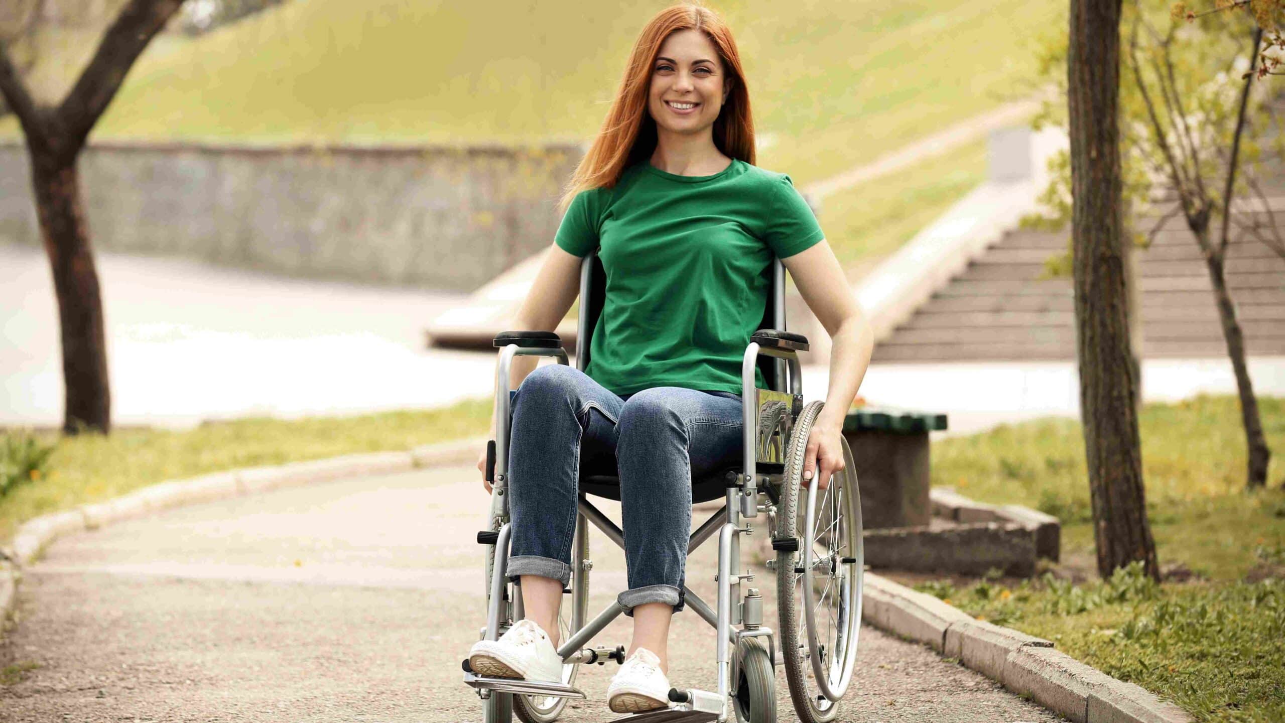 Young woman in a wheelchair smiling outside