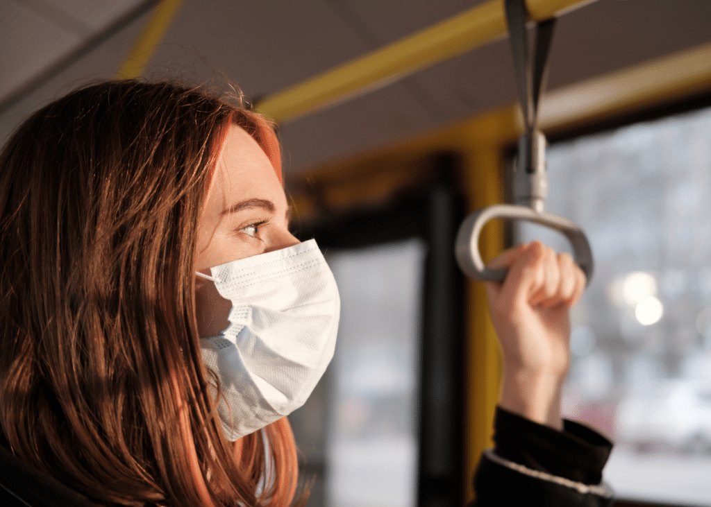 Woman wearing a mask on public transportation