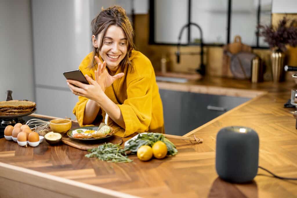 Woman cooking with using smart assisted device