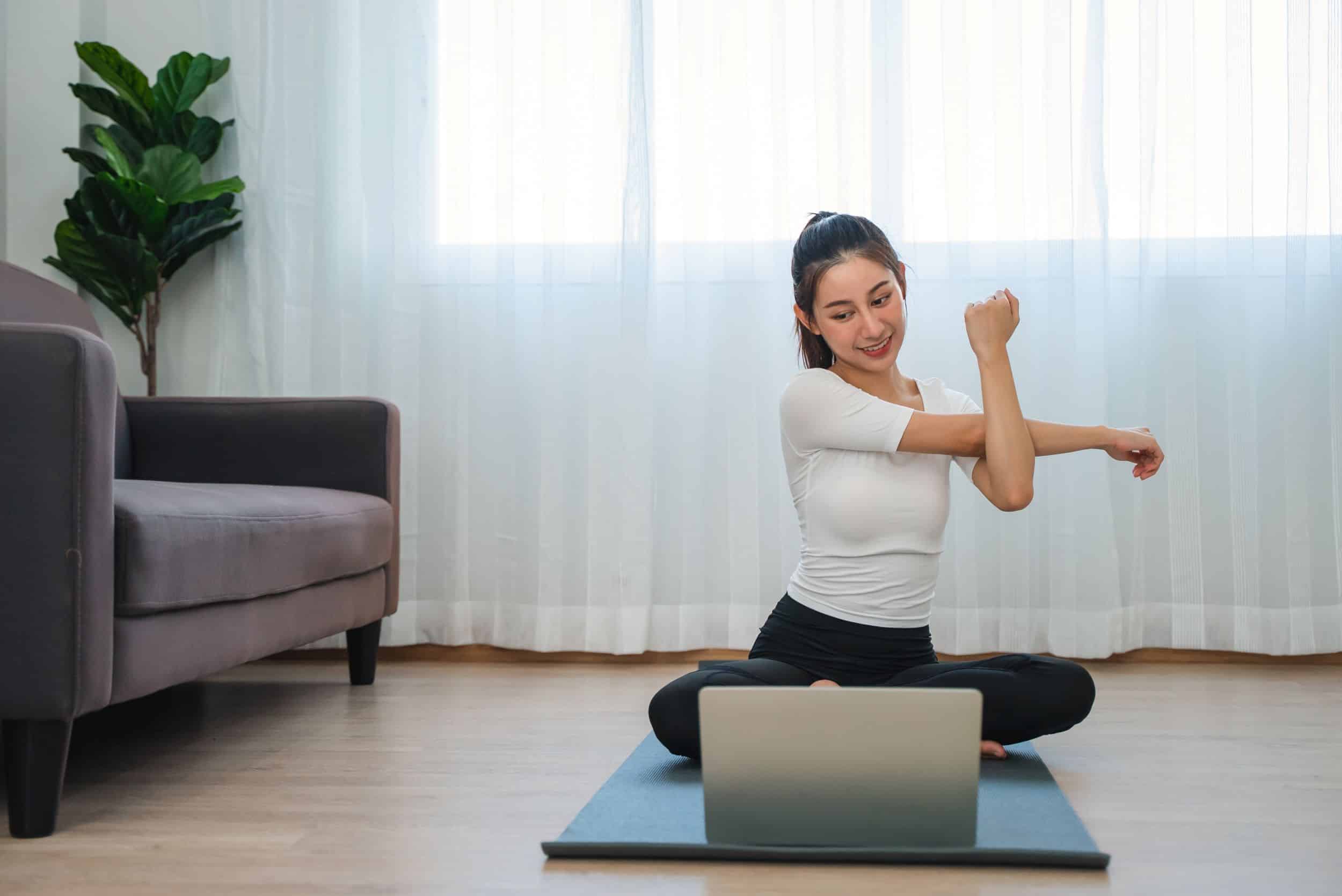 Young woman doing virtual yoga