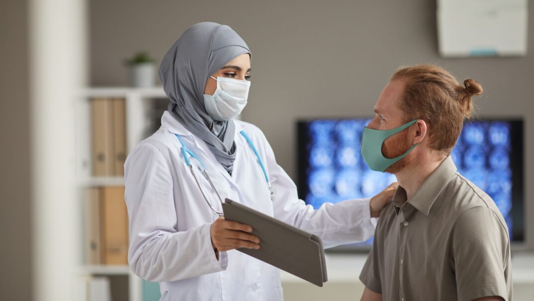 Female doctor talking with a male patient
