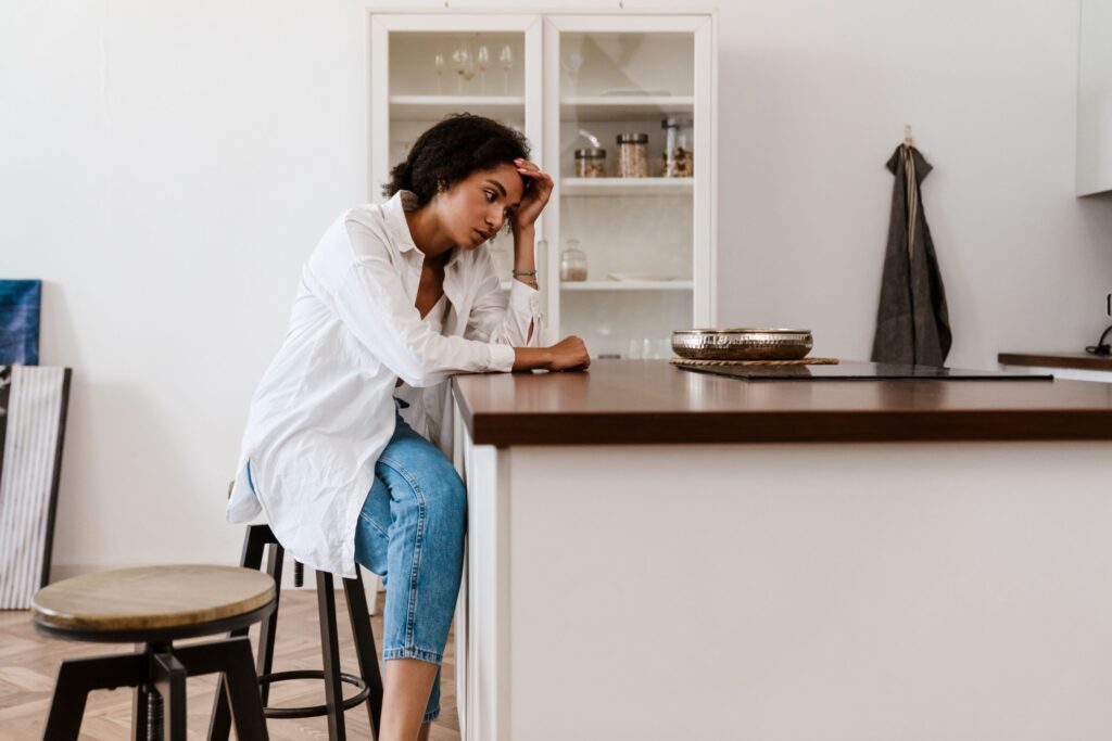 Woman sitting at a counter looking upset