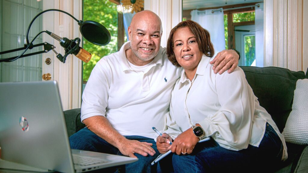 Man and woman sitting on couch together smiling