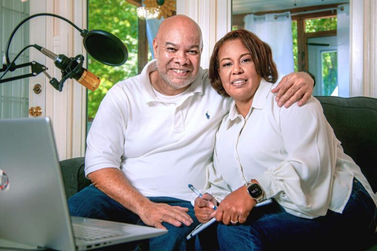 Man and woman sitting on couch together smiling