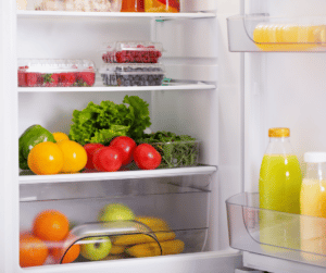 Open fridge with veggies and fruits inside