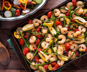 A tray with shrimp and veggies