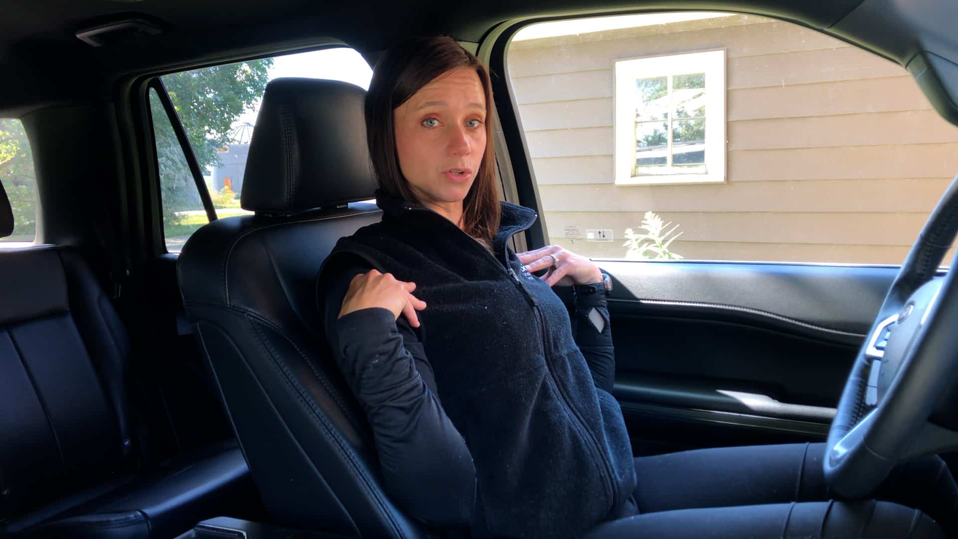 Physical therapist demonstrated should blade squeezes from her car