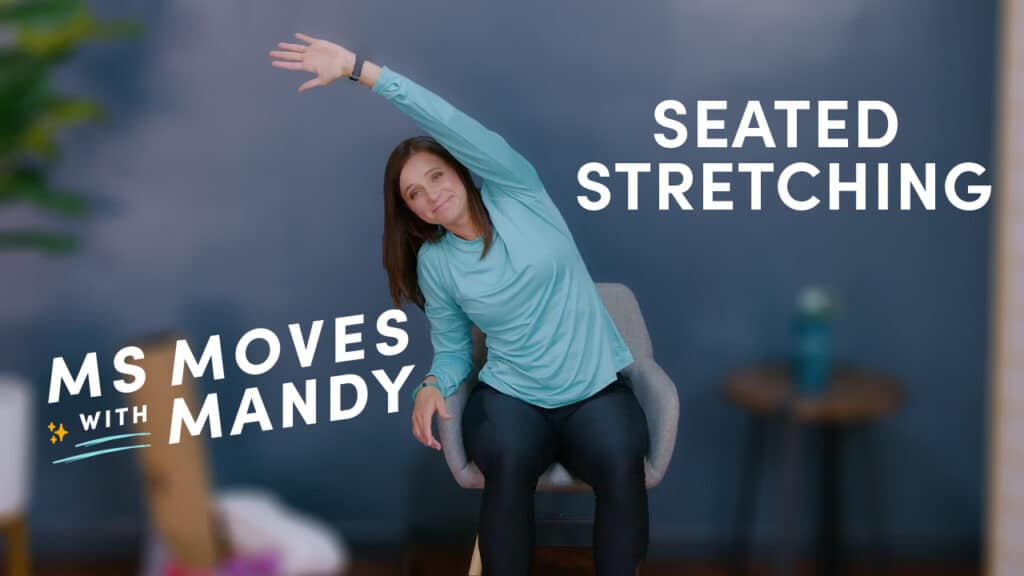Physical therapist demonstrating a seated stretch
