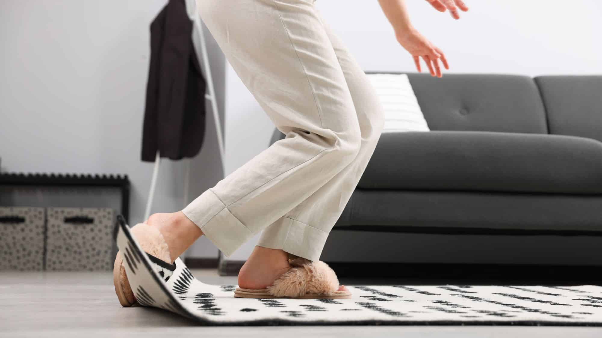 Person wearing slipper tripping on rug