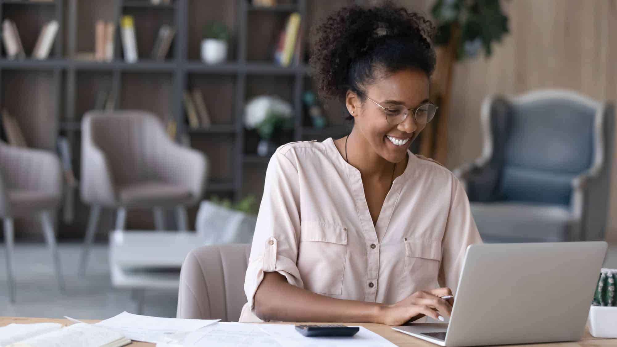 Woman working on computer smiling
