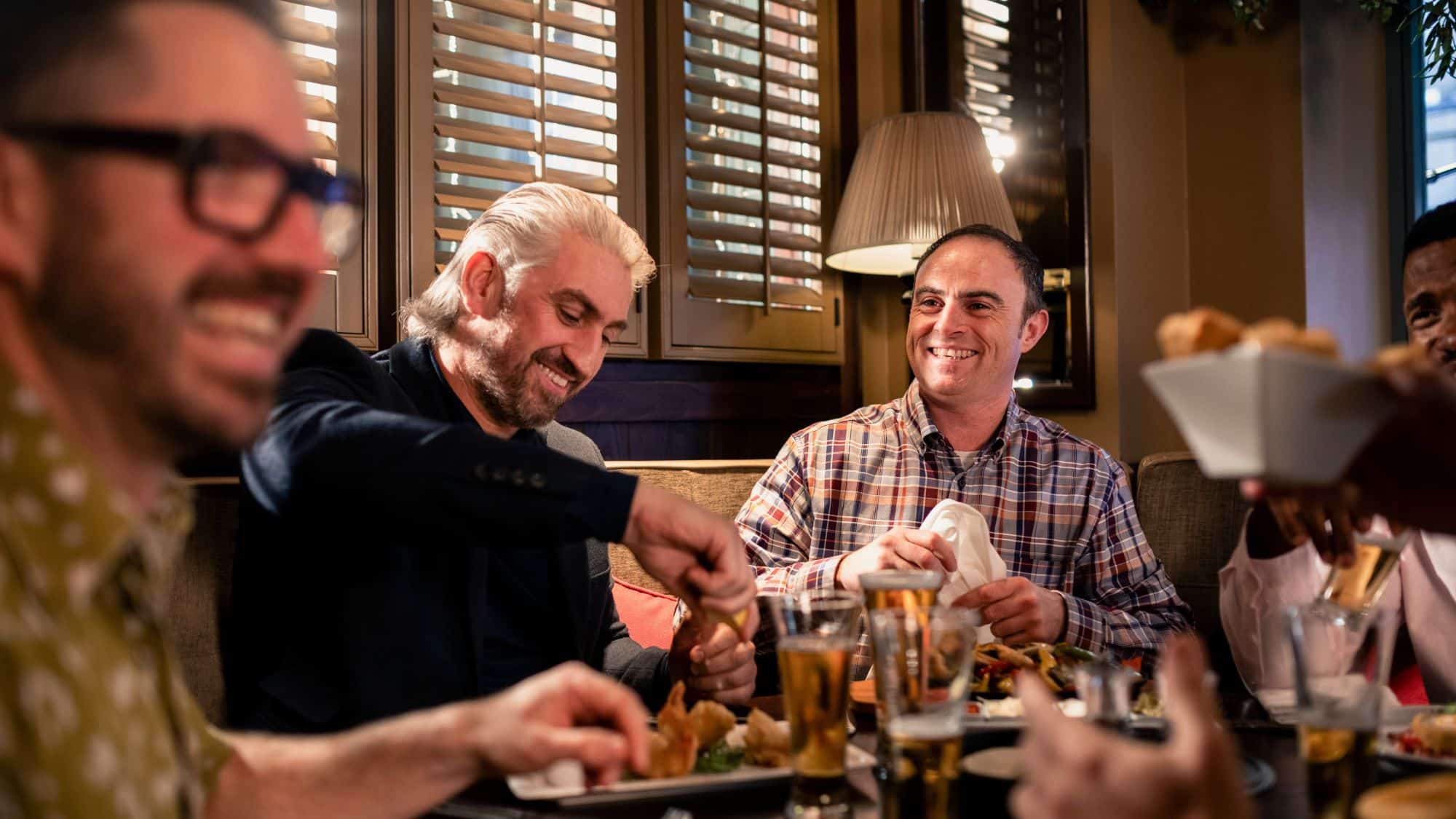 Men sitting at a restaurant eating