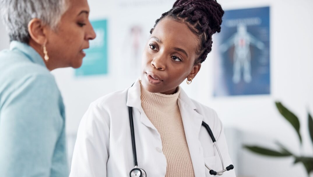 Doctor with older patient talking