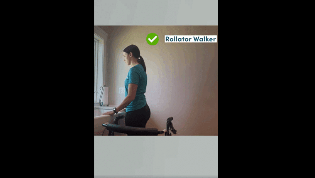 Mandy standing at her sink with her rollator next to her with the breaks on.