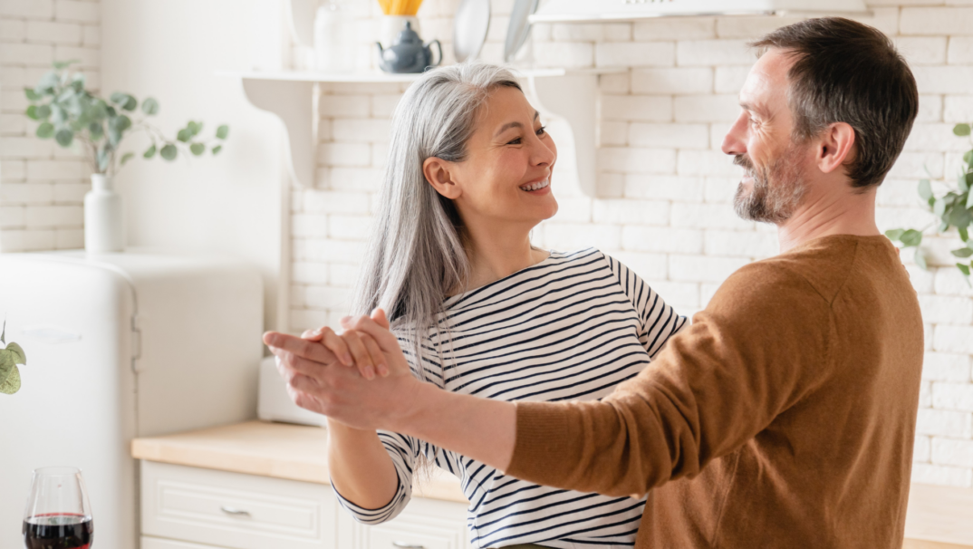 Couple dancing in the kitchen.